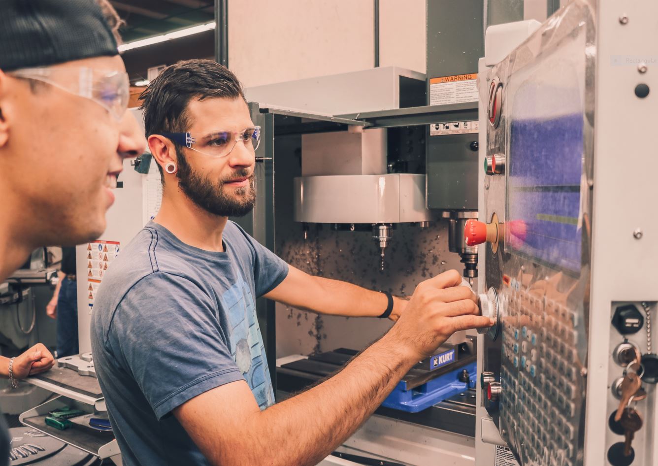 Two RTC students working in a machining lab