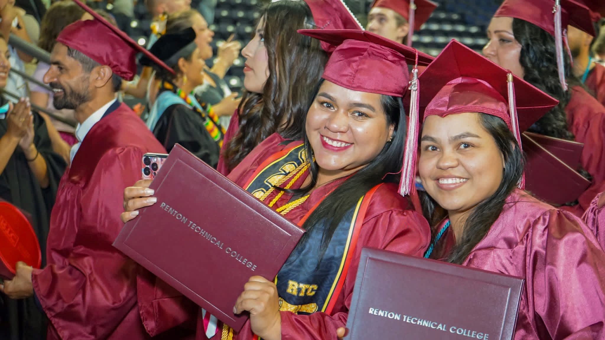 Two graduates smiling