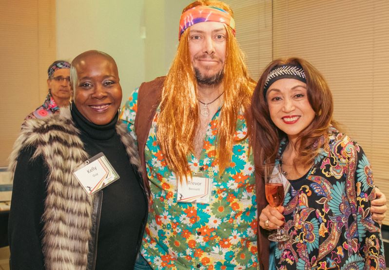 three people smiling in 60s outfit