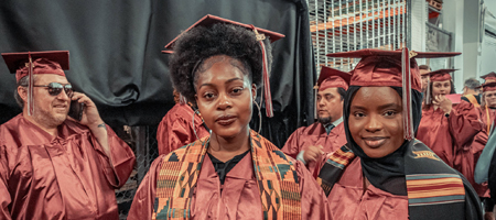 A group of students in cap and gowns at the commencement ceremony