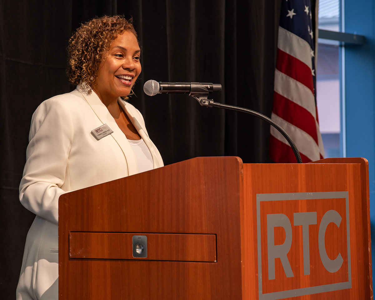 Dr. Yo speaking at the podium at RTC