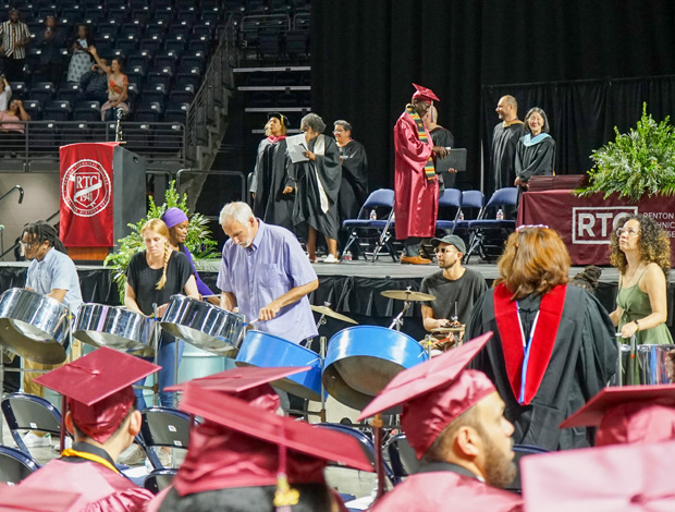 The stage, band, and the back of several graduates' heads at RTC's commencement ceremony