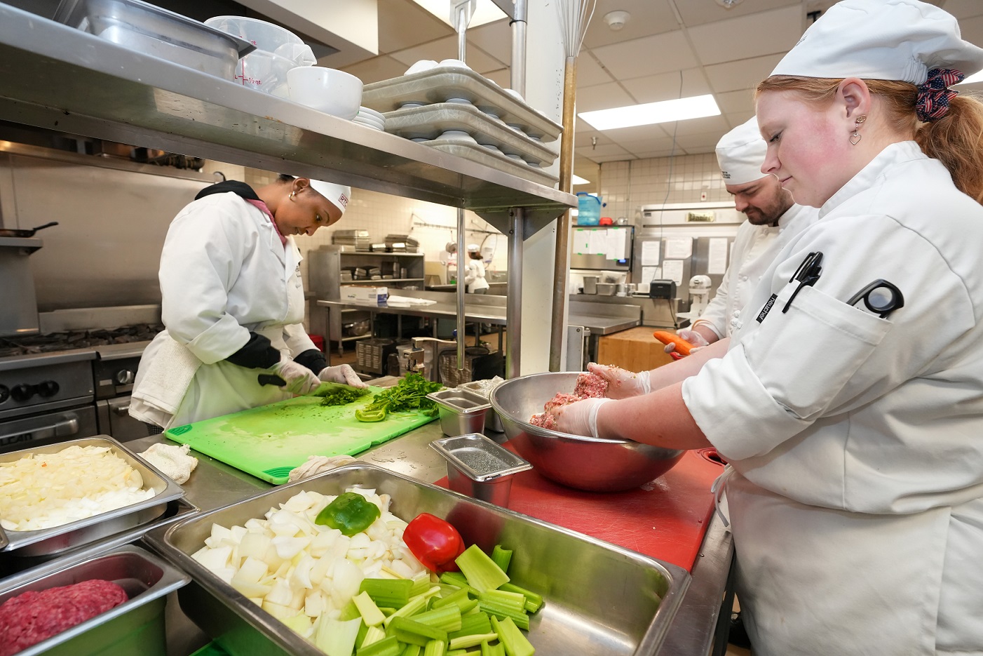 Three students preparing a meal.