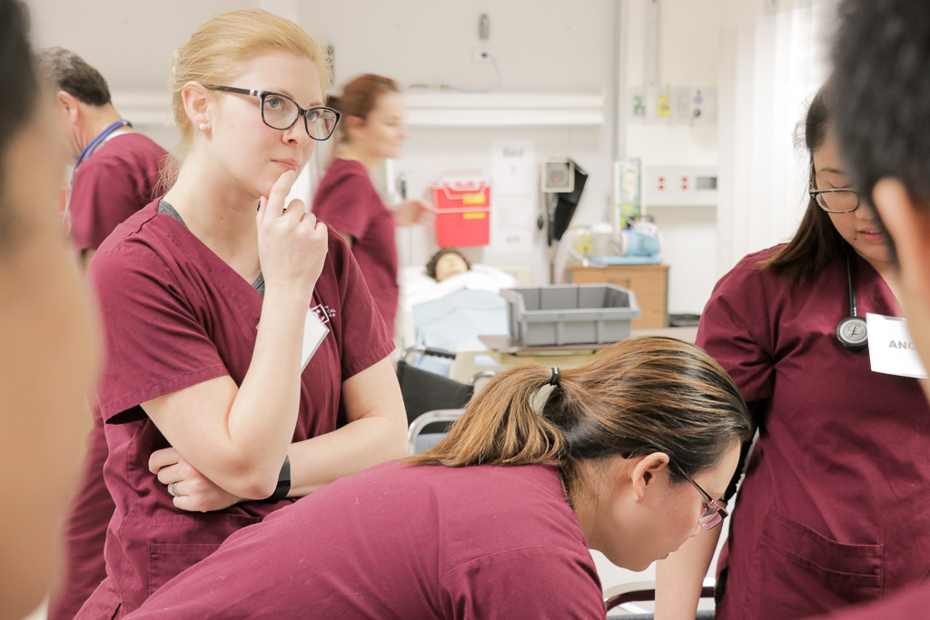 A nurse thinking behind two other nurses