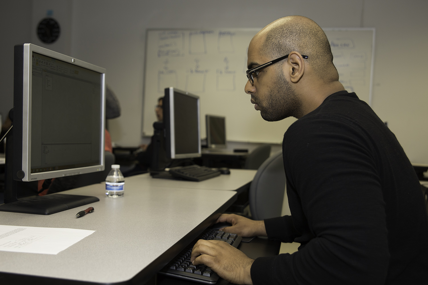 A man working intently at a computer.