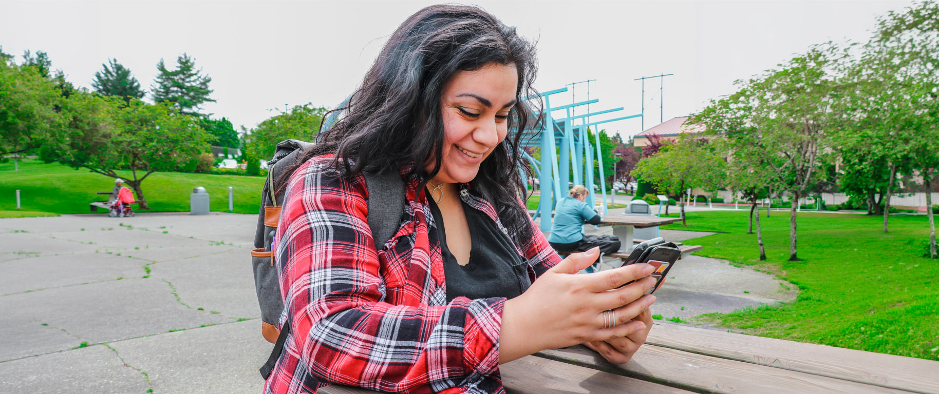 A student on her phone in front of I Building