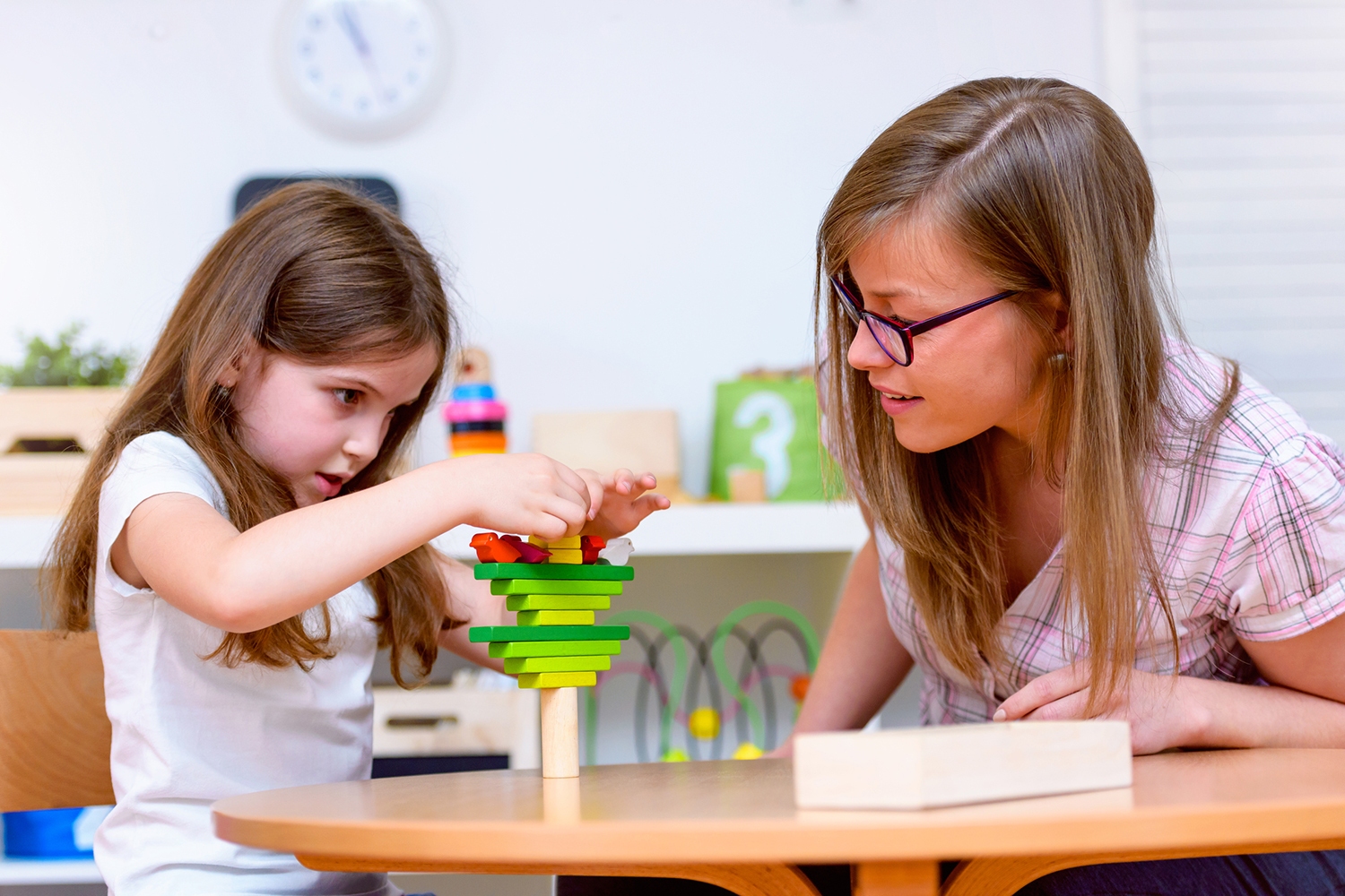 An educator watching a young child.