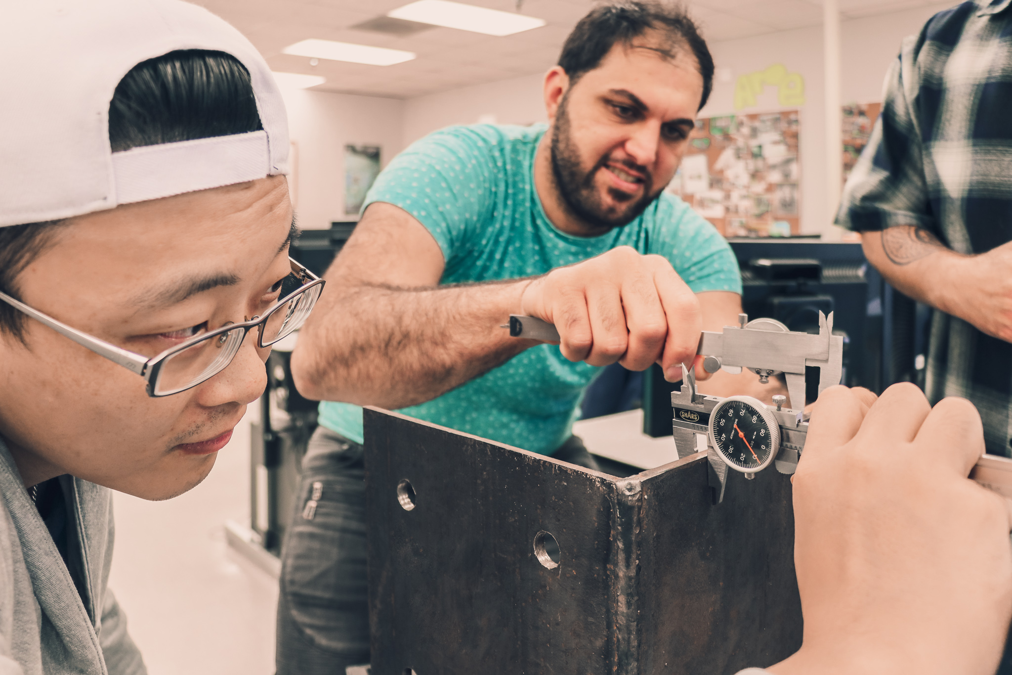 Two people engineering a piece of equipment.