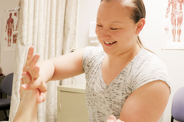 A massage therapist working on a patient.