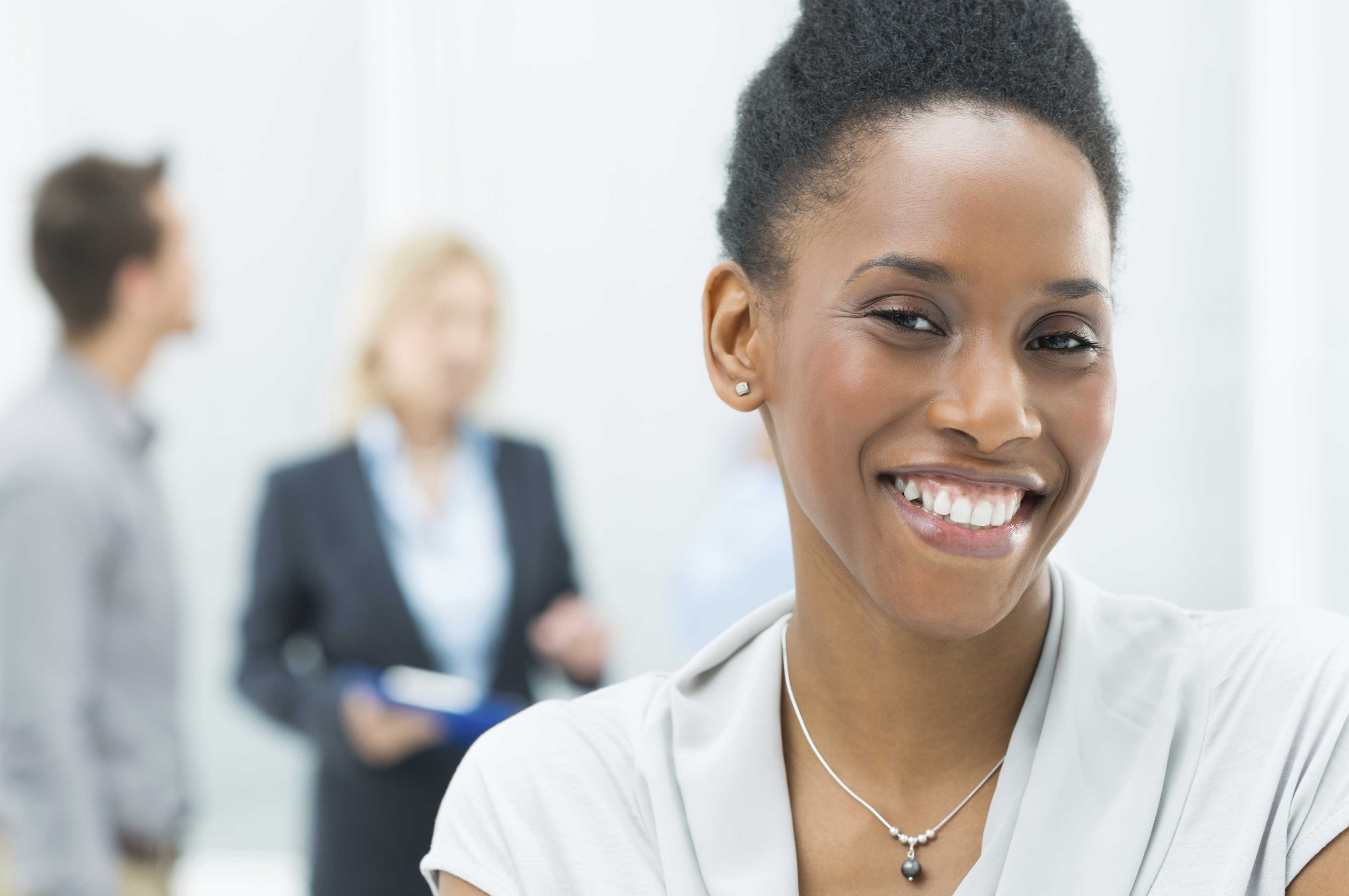 A woman smiling in an office.