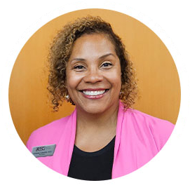 Dr. Harden in pink suit, smiling
