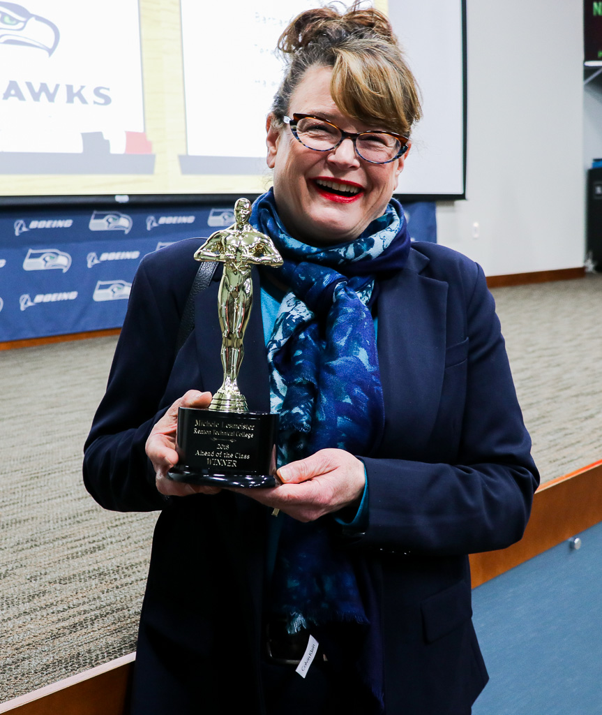 Photo of Michele Lesmeister holding her 2018 Ahead of the Class trophy.