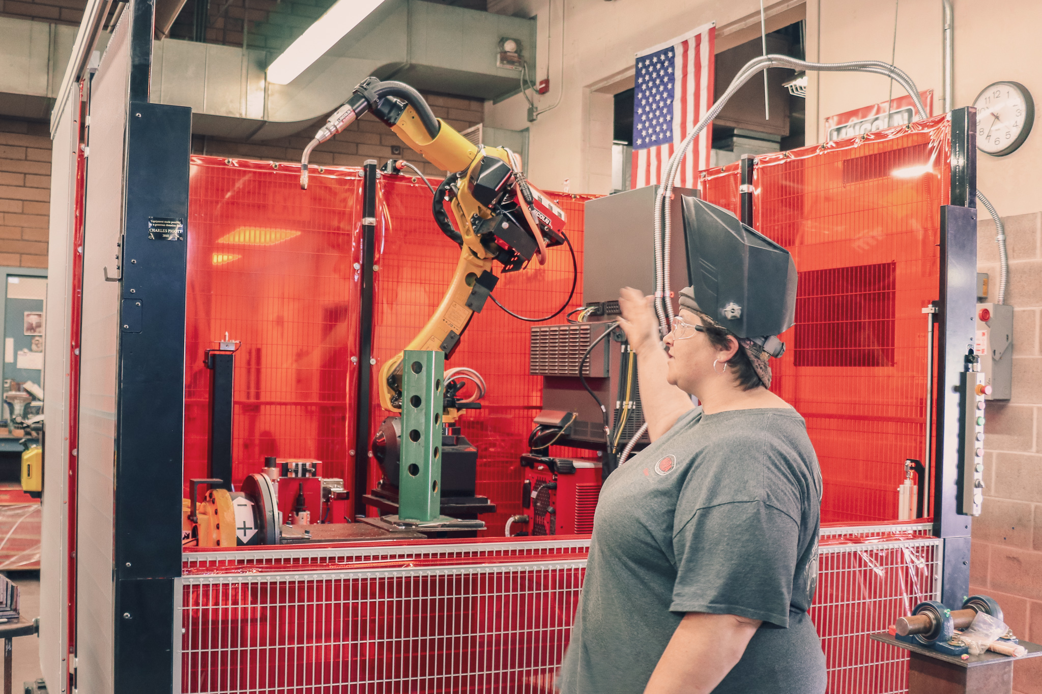 Rebecca Howard (welding student) showing the welding robot machine
