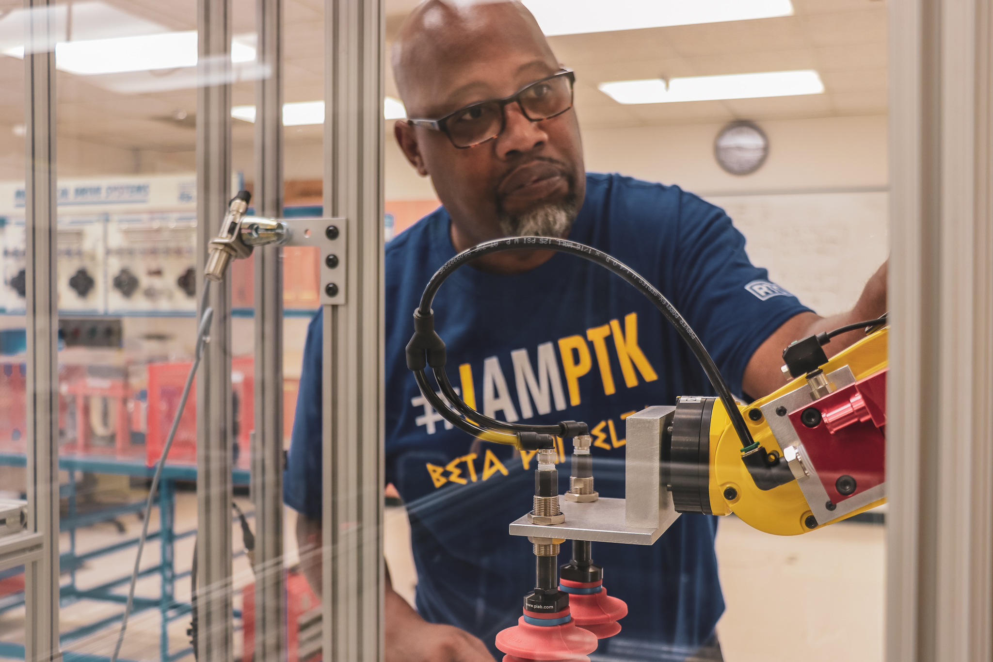 RTC student Michael Greer inspects the robotic machine 
