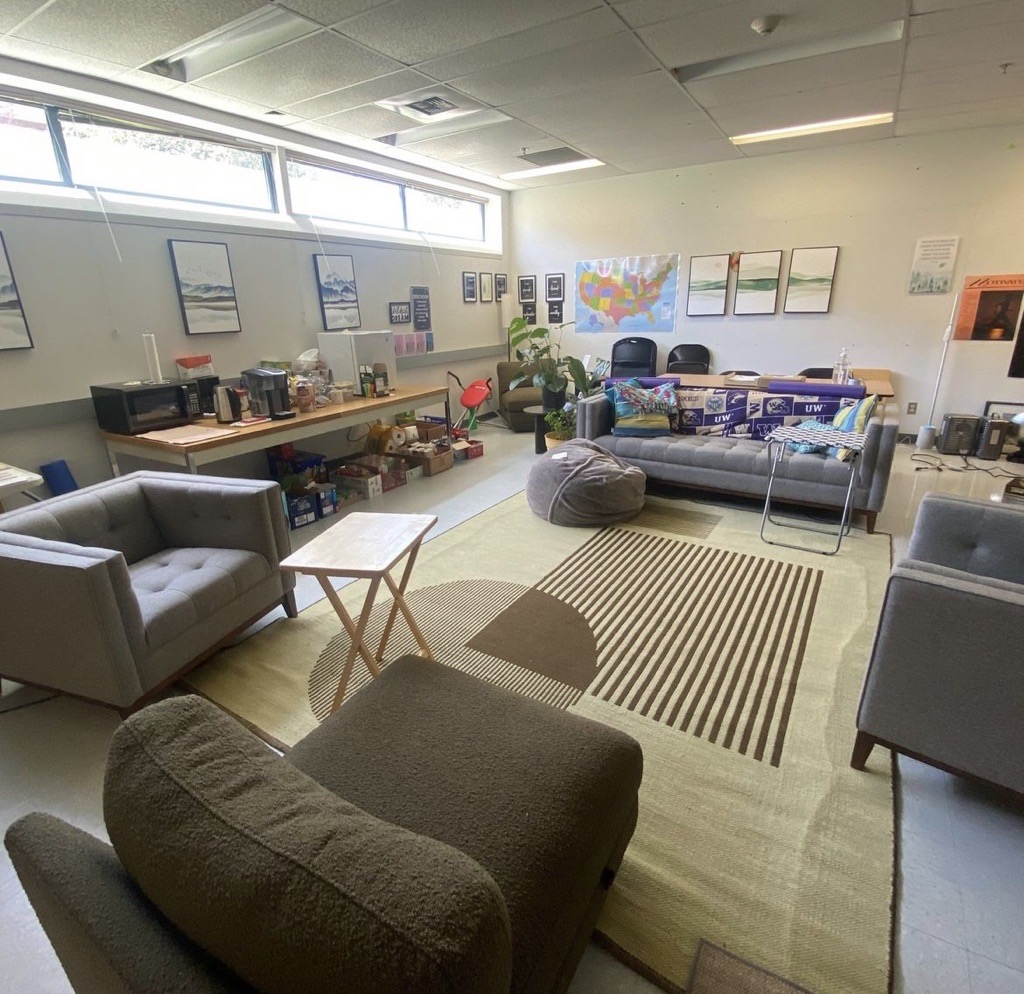 The RTC Wellbriety Center. A large, bright space with cozy couches and a table full of snacks and beverages.
