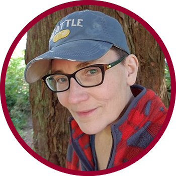 Zefire in a baseball cap, outdoors, smiling